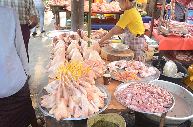 A chicken seller at a market in Yangon. Consumption of chicken and eggs has declined after chicken were killed by H5N1.