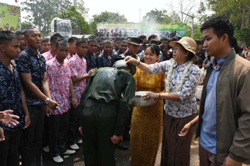 Daw Kyu Kyu Hla, wife of Senior General Min Aung Haing, enjoys water-throwing activities at pavilions in PyinOoLwin Station